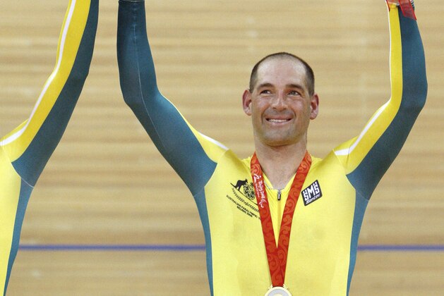 Australian Kieran Modra, right, and his pilot Tyson Lawrence waves during the medals presentation ceremony of the 4000m Individual Pursuit at the Beijing Paralympic Games in Beijing, China Sunday, Sept. 7, 2008. Kieran Modra and Tyson Lawrence won the gold medal and broke the world record at 4 minutes 18.961 sec. (AP Photo/Andy Wong)