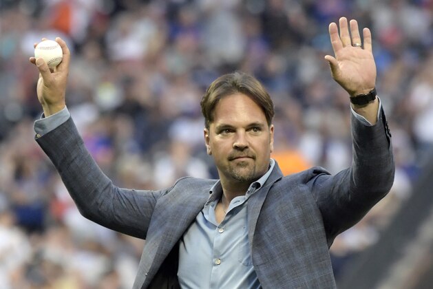 Former New York Mets catcher Mike Piazza acknowledges the fans before throwing out the ceremonial first pitch before a Mets baseball game against the New York Yankees, Saturday, June 9, 2018, in New York. (AP Photo/Bill Kostroun)