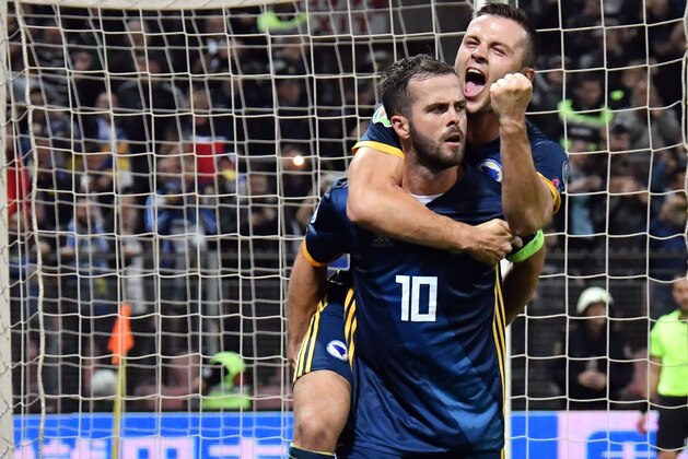 Bosnia-Herzegovina's midfielder Miralem Pjanic (front) and team mate forward Armin Hodzic (back) 
 celebrate after Pjanic scores for 2-0, during the UEFA Euro 2020 Group J qualifier football match between Bosnia-Herzegovina and Finland at the Bilino-Polje Stadium in Zenica, on October 12, 2019. (Photo by ELVIS BARUKCIC / AFP) (Photo by ELVIS BARUKCIC/AFP via Getty Images)