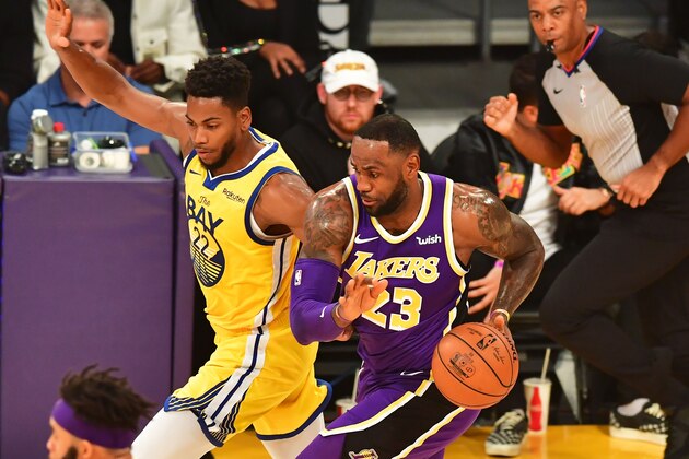Lebron James (R) of the Los Angeles Lakers dribbles under pressure from Glen Robinson (L) of the Golden State Warriors during the regular season at the Staples Center in Los Angeles on November 13, 2019. (Photo by Frederic J. BROWN / AFP) (Photo by FREDERIC J. BROWN/AFP via Getty Images)
