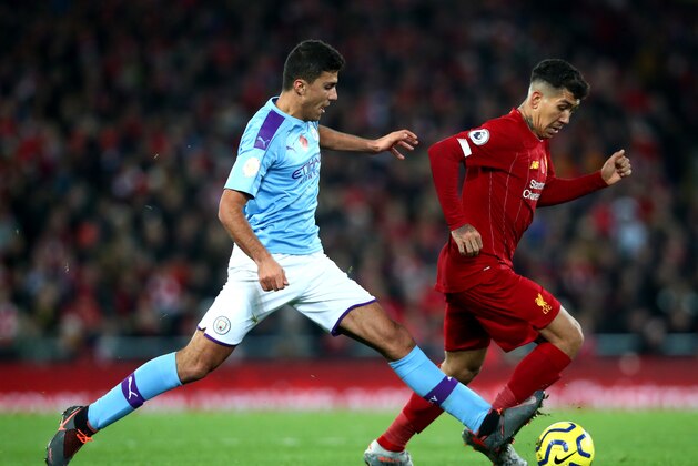 LIVERPOOL, ENGLAND - NOVEMBER 10: Rodrigo of Manchester City and Roberto Firmino of Liverpool in action during the Premier League match between Liverpool FC and Manchester City at Anfield on November 10, 2019 in Liverpool, United Kingdom. (Photo by Chloe Knott - Danehouse/Getty Images)