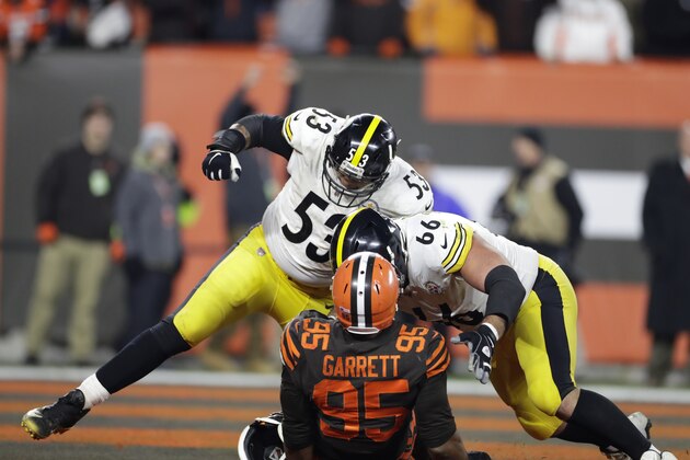 Cleveland Browns defensive end Myles Garrett (95) is taken down by Pittsburgh Steelers offensive guard David DeCastro (66) and Maurkice Pouncey (53) after pulling the helmet off quarterback Pittsburgh Steelers quarterback Mason Rudolph during the second half of an NFL football game, Thursday, Nov. 14, 2019, in Cleveland. (AP Photo/Ron Schwane)
