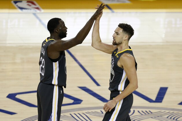 OAKLAND, CALIFORNIA - JUNE 07:  Draymond Green #23 congratulates Klay Thompson #11 of the Golden State Warriors in the first half against the Toronto Raptors during Game Four of the 2019 NBA Finals at ORACLE Arena on June 07, 2019 in Oakland, California. NOTE TO USER: User expressly acknowledges and agrees that, by downloading and or using this photograph, User is consenting to the terms and conditions of the Getty Images License Agreement. (Photo by Lachlan Cunningham/Getty Images)