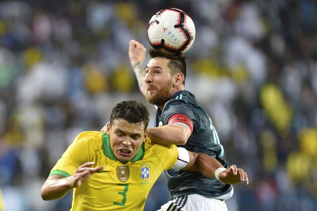 Argentina's Lionel Messi, right, heads the ball past Brazil's Thiago Silva during a friendly soccer match between Brazil and Argentina at King Fahd stadium in Riyadh, Saudi Arabia, Friday, Nov. 15, 2019. (AP Photo)