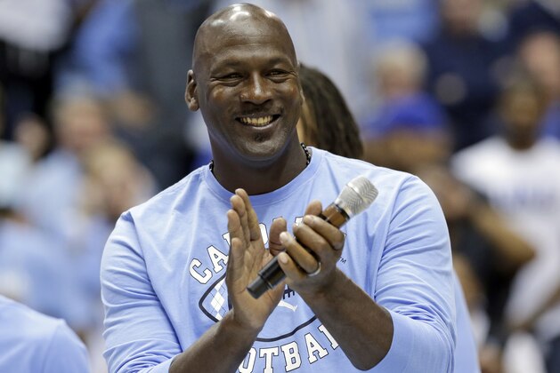 FILE - In this March 4, 2017, file photo, former North Carolina basketball player Michael Jordan applauds during a half-time presentation at an NCAA college basketball game between North Carolina and Duke in Chapel Hill, N.C. Jordan, who played high school basketball in Wilmington, N.C., one of the areas hardest hit by Hurricane Florence, has donated $2 million to assist residents affected by the hurricane. (AP Photo/Gerry Broome, File)
