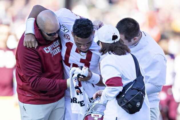 FAYETTEVILLE, AR - NOVEMBER 9:   Tua Tagovailoa #13 of the Alabama Crimson Tide is helped off the field after being injured on a play in the first half of a game against the Mississippi State Bulldogs at Davis Wade Stadium on November 16, 2019 in Starkville, Mississippi.  (Photo by Wesley Hitt/Getty Images)