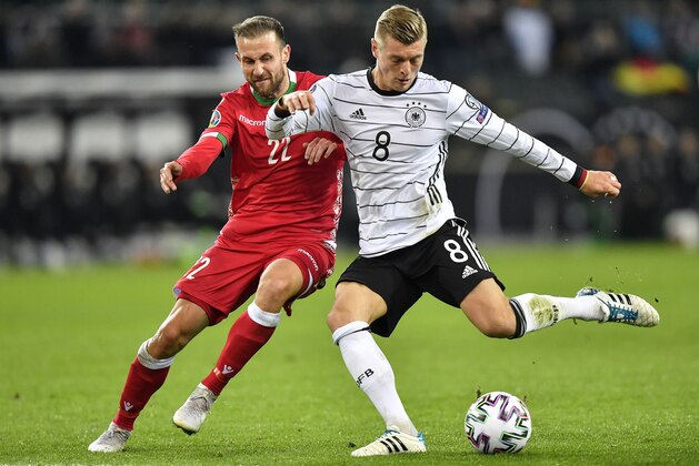 Germany's Toni Kroos, right, and Belarus' Igor Stasevich challenge for the ball during the Euro 2020 group C qualifying soccer match between Germany and Belarus in Moenchengladbach, Germany, Saturday, Nov. 16, 2019. (AP Photo/Martin Meissner)