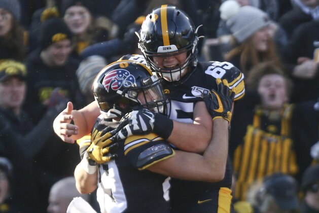 IOWA CITY, IOWA- NOVEMBER 16:  Wide receiver Nico Ragaini #89 celebrates with offensive lineman Tyler Linderbaum #65 of the Iowa Hawkeyes after a touchdown during the first half against the Minnesota Gophers on November 16, 2019 at Kinnick Stadium in Iowa City, Iowa.  (Photo by Matthew Holst/Getty Images)