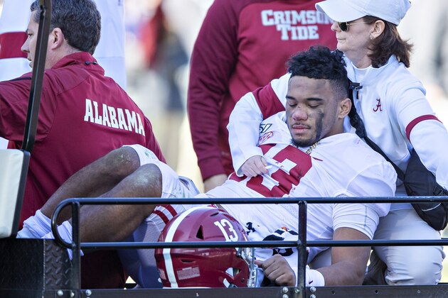 FAYETTEVILLE, AR - NOVEMBER 9:   Tua Tagovailoa #13 of the Alabama Crimson Tide is helped off the field after being injured on a play in the first half of a game against the Mississippi State Bulldogs at Davis Wade Stadium on November 16, 2019 in Starkville, Mississippi.  (Photo by Wesley Hitt/Getty Images)