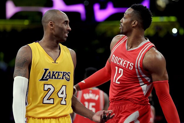 Los Angeles Lakers forward Kobe Bryant, left, and Houston Rockets center Dwight Howard chat during the second half of an NBA basketball game in Los Angeles, Thursday, Dec. 17, 2015. (AP Photo/Chris Carlson)