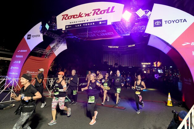 LAS VEGAS, NEVADA - NOVEMBER 11:  Runners cross the finish line of the Toyota Rock 'n' Roll Las Vegas Half Marathon on the Las Vegas Strip on November 11, 2018 in Las Vegas, Nevada.  (Photo by Ethan Miller/Getty Images)