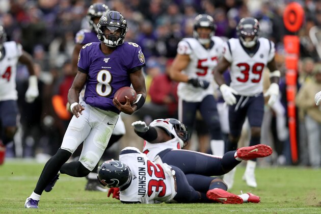 BALTIMORE, MARYLAND - NOVEMBER 17: Lamar Jackson #8 of the Baltimore Ravens rushes for a first down in the third quarter against the Houston Texans at M&T Bank Stadium on November 17, 2019 in Baltimore, Maryland. (Photo by Rob Carr/Getty Images)