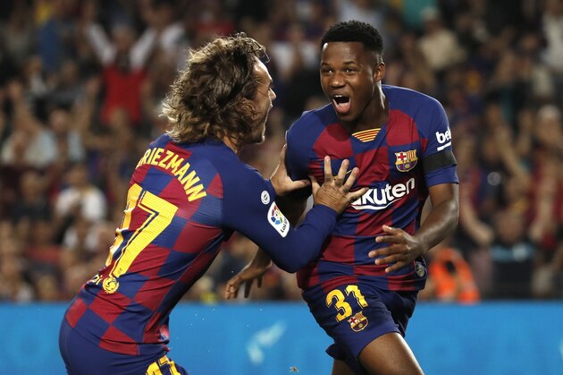 Barcelona's Ansu Fati, right, celebrates with teammate Barcelona's Antoine Griezmann after scoring the opening goal during the Spanish La Liga soccer match between FC Barcelona and Valencia CF at the Camp Nou stadium in Barcelona, Spain, Saturday, Sep. 14, 2019. (AP Photo/Joan Monfort)