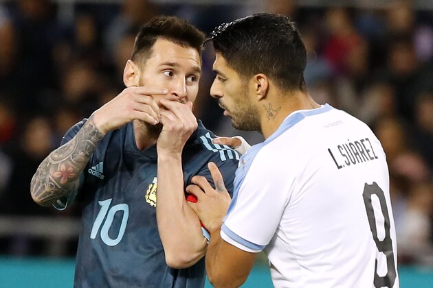 Argentina's forward Lionel Messi talks with Uruguay's forward Luis Suarez during the friendly football match between Argentina and Uruguay at the Bloomfield stadium in the Israeli coastal city of Tel Aviv on November 18, 2019. (Photo by Jack GUEZ / AFP) (Photo by JACK GUEZ/AFP via Getty Images)