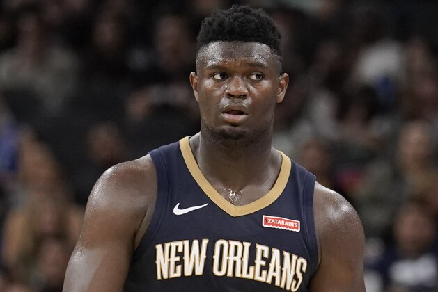 New Orleans Pelicans' Zion Williamson walks upcourt during the second half of an NBA preseason basketball game against the San Antonio Spurs, Sunday, Oct. 13, 2019, in San Antonio. (AP Photo/Darren Abate)