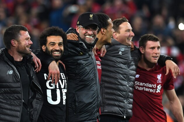 Liverpool's Egyptian midfielder Mohamed Salah (2L), Liverpool's German manager Jurgen Klopp (C) and Liverpool's Dutch defender Virgil van Dijk celebrate after winning the UEFA Champions league semi-final second leg football match between Liverpool and Barcelona at Anfield in Liverpool, north west England on May 7, 2019. (Photo by Paul ELLIS / AFP)        (Photo credit should read PAUL ELLIS/AFP via Getty Images)