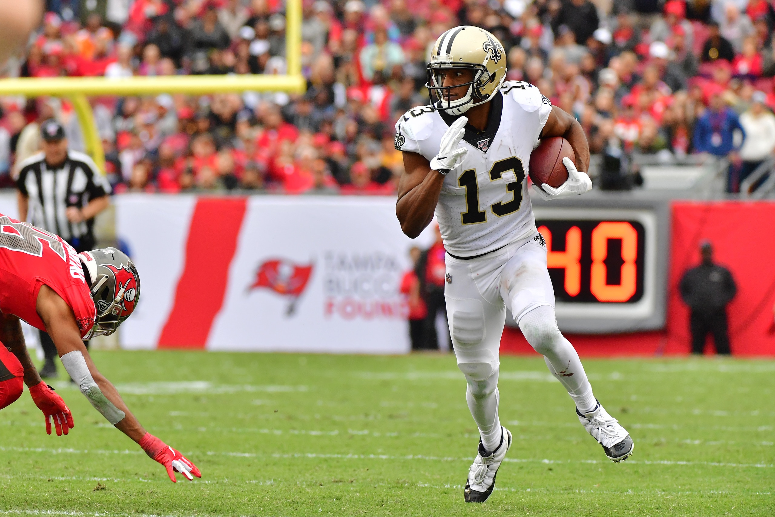 TAMPA, FLORIDA - NOVEMBER 17: Michael Thomas #13 of the New Orleans Saints runs the ball during the third quarter of a football game against the Tampa Bay Buccaneers at Raymond James Stadium on November 17, 2019 in Tampa, Florida. (Photo by Julio Aguilar/Getty Images)