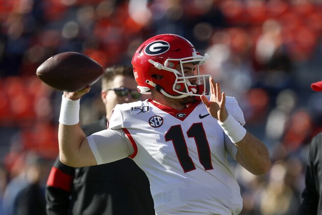 Georgia quarterback Jake Fromm (11) warms up before an NCAA college football game against Auburn, Saturday, Nov. 16, 2019, in Auburn, Ala. (AP Photo/Butch Dill)