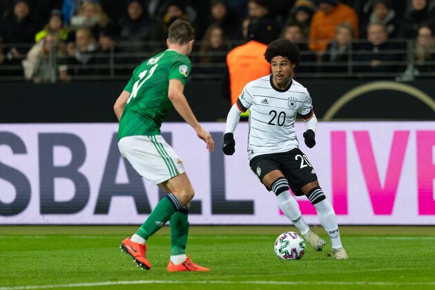 FRANKFURT AM MAIN, GERMANY - NOVEMBER 19: Paddy Mc Nair of North Ireland and Serge Gnabry of Germany battle for the ball during the UEFA Euro 2020 Qualifier between Germany and Northern Ireland at Commerzbank Arena on November 19, 2019 in Frankfurt am Main, Germany. (Photo by TF-Images/Getty Images)