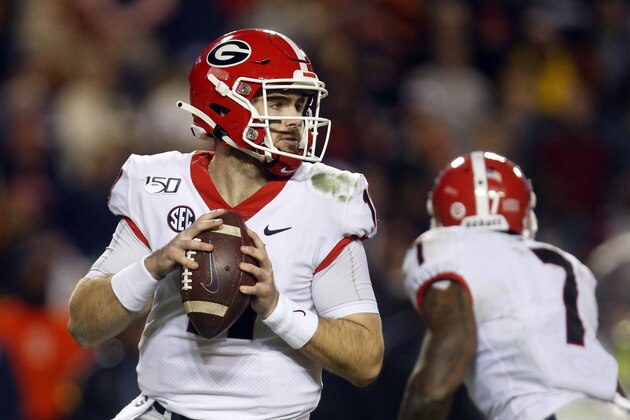 Georgia quarterback Jake Fromm (11) drops back to pass against Auburn during the second half of an NCAA college football game, Saturday, Nov. 16, 2019, in Auburn, Ala. (AP Photo/Butch Dill)