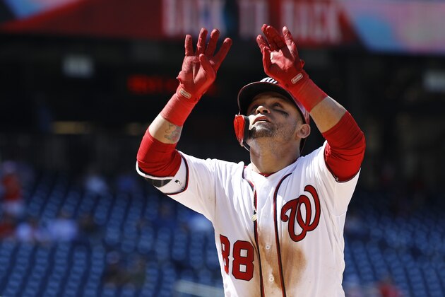 Washington Nationals' Gerardo Parra gestures as he crosses home plate after rounding the bases on a solo home run in the eighth inning of the first baseball game of a doubleheader against the Philadelphia Phillies, Wednesday, June 19, 2019, in Washington. Washington won 6-2. (AP Photo/Patrick Semansky)