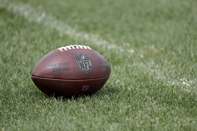 A football lays on the grass during New York Giants NFL football rookie minicamp , Friday, May 12, 2017, in East Rutherford, N.J. (AP Photo/Julio Cortez)