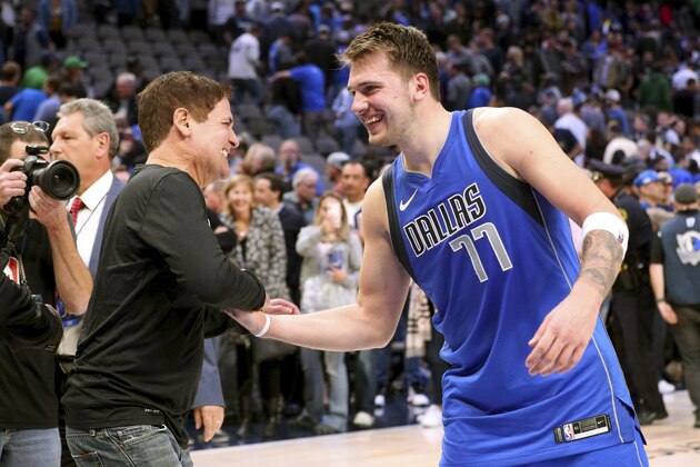 Dallas Mavericks owner Mark Cuban shakes hands with Luka Doncic (77) after the 117-110 win over the San Antonio Spurs in an NBA basketball game Monday, Nov. 18, 2019, in Dallas. (AP Photo/Richard W. Rodriguez)