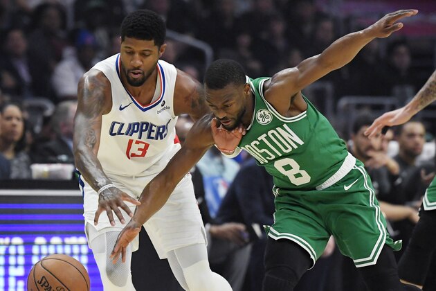 Los Angeles Clippers forward Paul George, left, and Boston Celtics guard Kemba Walker go after a loose ball during the first half of an NBA basketball game Wednesday, Nov. 20, 2019, in Los Angeles. (AP Photo/Mark J. Terrill)