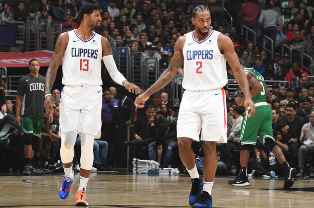 LOS ANGELES, CA - NOVEMBER 20: Paul George #13, and Kawhi Leonard #2 of the LA Clippers look on against the Boston Celtics on November 20, 2019 at STAPLES Center in Los Angeles, California. NOTE TO USER: User expressly acknowledges and agrees that, by downloading and/or using this Photograph, user is consenting to the terms and conditions of the Getty Images License Agreement. Mandatory Copyright Notice: Copyright 2019 NBAE (Photo by Andrew D. Bernstein/NBAE via Getty Images)