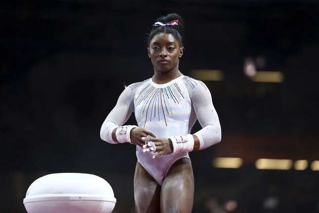 Simone Biles of the United States gets ready to perform on the uneven bars in the women's all-around final at the Gymnastics World Championships in Stuttgart, Germany, Thursday, Oct. 10, 2019. (AP Photo/Matthias Schrader)