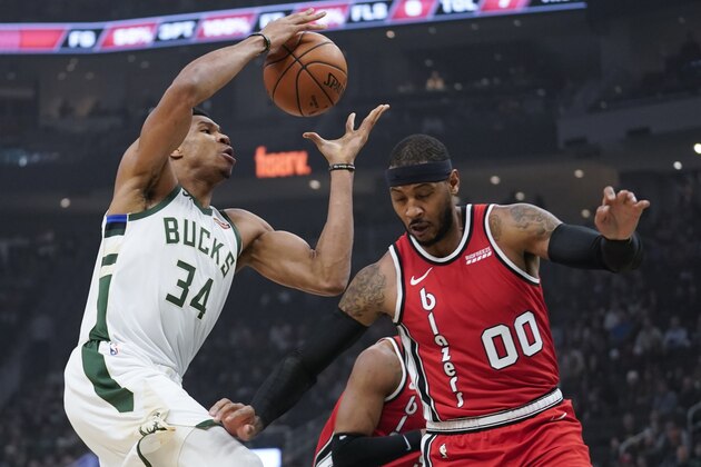 Milwaukee Bucks' Giannis Antetokounmpo shoots over Portland Trail Blazers' Carmelo Anthony during the first half of an NBA basketball game Thursday, Nov. 21, 2019, in Milwaukee. (AP Photo/Morry Gash)