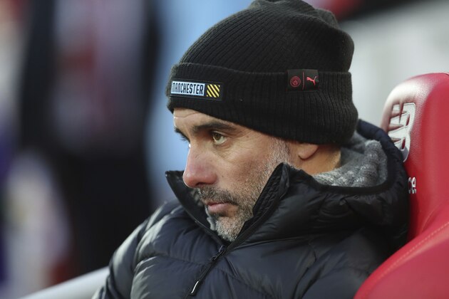 Manchester City's head coach Pep Guardiola, watches from the bench prior to the start of the English Premier League soccer match between Liverpool and Manchester City at Anfield stadium in Liverpool, England, Sunday, Nov. 10, 2019. (AP Photo/Jon Super)