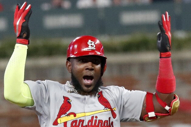 CORRECTS TO DOUBLE, INSTEAD OF SINGLE  - St. Louis Cardinals' Marcell Ozuna celebrates his two-run double against the Atlanta Braves in the ninth inning during Game 1 of a best-of-five National League Division Series, Thursday, Oct. 3, 2019, in Atlanta. (AP Photo/John Bazemore)