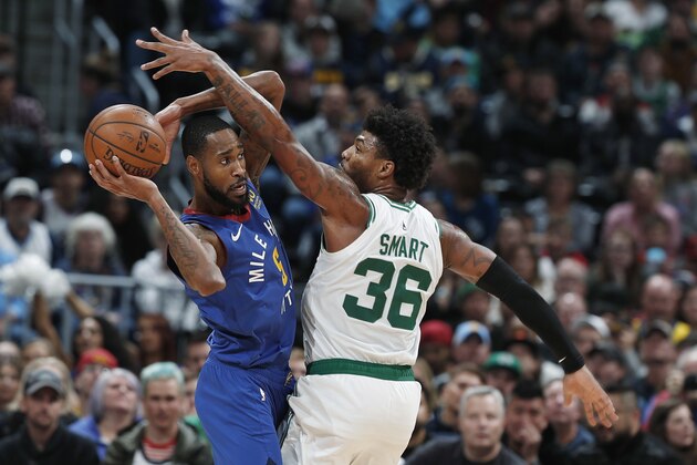 Denver Nuggets guard Will Barton, left, looks to pass the ball as Boston Celtics guard Marcus Smart defends during the second half of an NBA basketball game Friday, Nov. 22, 2019, in Denver. The Nuggets won 96-92. (AP Photo/David Zalubowski)