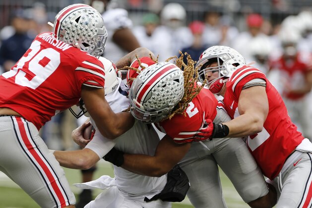 Ohio State defenders, left to right, Malik Harrison, Chase Young and Tuf Borland sack Penn State quarterback Sean Clifford during the first half of an NCAA college football game Saturday, Nov. 23, 2019, in Columbus, Ohio. (AP Photo/Jay LaPrete)