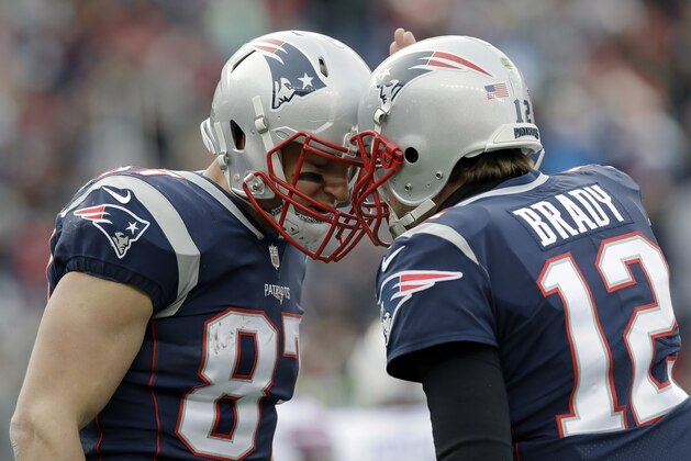 New England Patriots quarterback Tom Brady, right, celebrates his touchdown pass to tight end Rob Gronkowski, left, during the first half of an NFL football game against the Buffalo Bills, Sunday, Dec. 24, 2017, in Foxborough, Mass. (AP Photo/Charles Krupa)