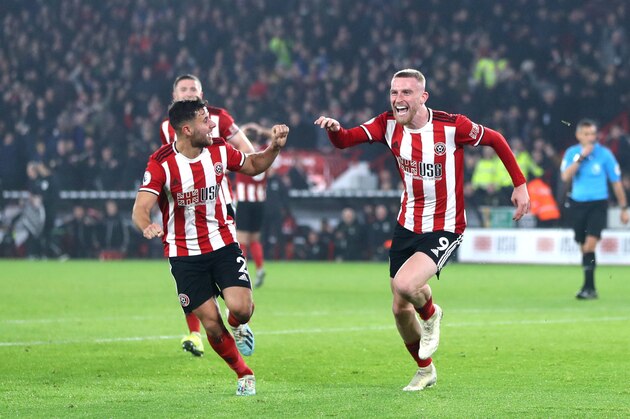 SHEFFIELD, ENGLAND - NOVEMBER 24: Oli McBurnie of Sheffield United celebrates scoring his teams third goal during the Premier League match between Sheffield United and Manchester United at Bramall Lane on November 24, 2019 in Sheffield, United Kingdom. (Photo by Chloe Knott - Danehouse/Getty Images)