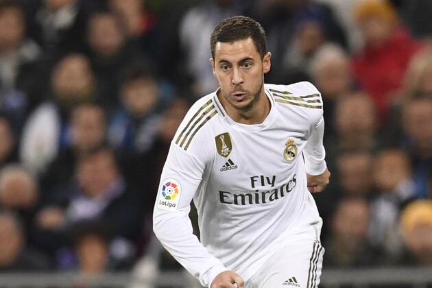 Real Madrid's Belgian forward Eden Hazard dribbles the ball during the Spanish league football match Real Madrid CF against Real Sociedad at the Santiago Bernabeu stadium in Madrid on November 23, 2019. (Photo by PIERRE-PHILIPPE MARCOU / AFP) (Photo by PIERRE-PHILIPPE MARCOU/AFP via Getty Images)