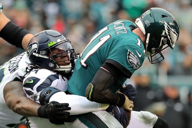 PHILADELPHIA, PENNSYLVANIA - NOVEMBER 24: Quinton Jefferson #99 and Ezekiel Ansah #94 of the Seattle Seahawks sack quarterback Carson Wentz #11 of the Philadelphia Eagles in the first half at Lincoln Financial Field on November 24, 2019 in Philadelphia, Pennsylvania. (Photo by Elsa/Getty Images)