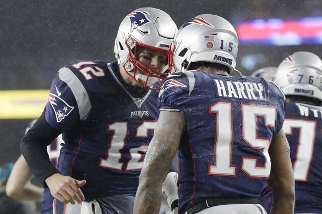 New England Patriots quarterback Tom Brady, left, celebrates his touchdown pass to wide receiver N'Keal Harry, right, in the first half of an NFL football game against the Dallas Cowboys, Sunday, Nov. 24, 2019, in Foxborough, Mass. (AP Photo/Elise Amendola)
