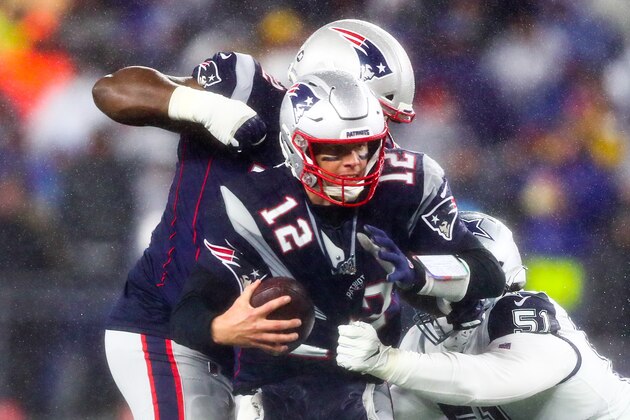 FOXBOROUGH, MA - NOVEMBER 24:   Tom Brady #12 of the New England Patriots is sacked by Kerry Hyder #51 of the Dallas Cowboys during a game at Gillette Stadium on November 24, 2019 in Foxborough, Massachusetts.  (Photo by Adam Glanzman/Getty Images)