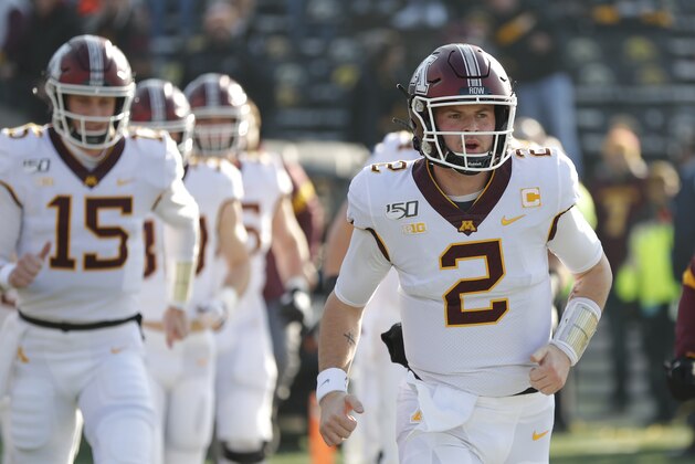 Minnesota quarterback Tanner Morgan leads the team onto the field for warm ups before an NCAA college football game against Iowa, Saturday, Nov. 16, 2019, in Iowa City, Iowa. (AP Photo/Matthew Putney)