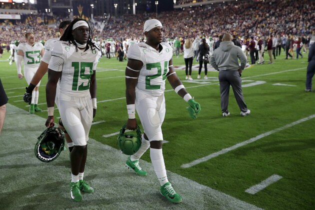 Oregon safety Jamal Hill (19) and linebacker Ge'mon Eaford leave the field after the team's NCAA college football game against Arizona State, Saturday, Nov. 23, 2019, in Tempe, Ariz. Arizona State won 31-28. (AP Photo/Matt York)