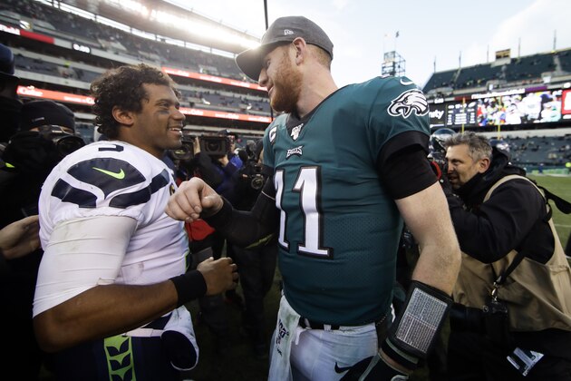 Seattle Seahawks' Russell Wilson, left, and Philadelphia Eagles' Carson Wentz meet after an NFL football game, Sunday, Nov. 24, 2019, in Philadelphia. Seattle won 17-9. (AP Photo/Matt Rourke)