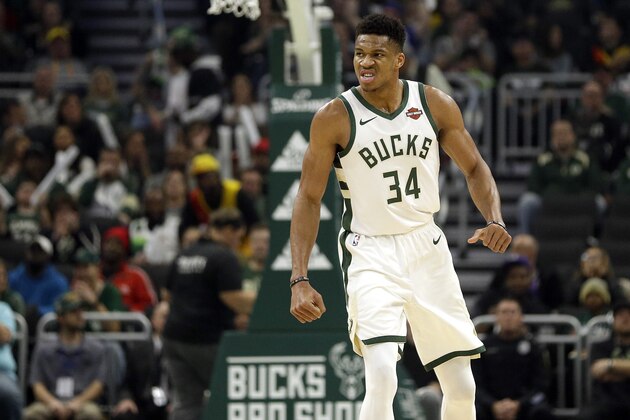 Milwaukee Bucks' Giannis Antetokounmpo reacts after dunking during the first half of an NBA basketball game against the Utah Jazz Monday, Nov. 25, 2019, in Milwaukee. (AP Photo/Aaron Gash)