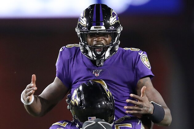 LOS ANGELES, CALIFORNIA - NOVEMBER 25:  Quarterback Lamar Jackson #8 of the Baltimore Ravens celebrates his second pass for a touchdown to wide receiver Marquise Brown #15  in the first quarter of the game against the Los Angeles Rams at Los Angeles Memorial Coliseum on November 25, 2019 in Los Angeles, California. (Photo by Sean M. Haffey/Getty Images)