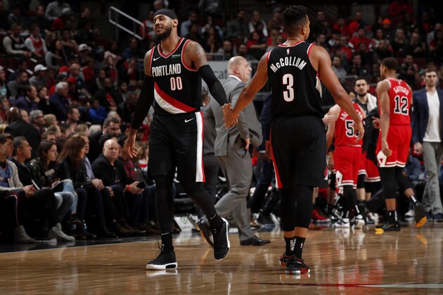 CHICAGO, IL - NOVEMBER 25: Carmelo Anthony #00, and CJ McCollum #3 of the Portland Trail Blazers hi-five each other against the Chicago Bulls on November 25, 2019 at United Center in Chicago, Illinois. NOTE TO USER: User expressly acknowledges and agrees that, by downloading and or using this photograph, User is consenting to the terms and conditions of the Getty Images License Agreement. Mandatory Copyright Notice: Copyright 2019 NBAE (Photo by Jeff Haynes/NBAE via Getty Images)