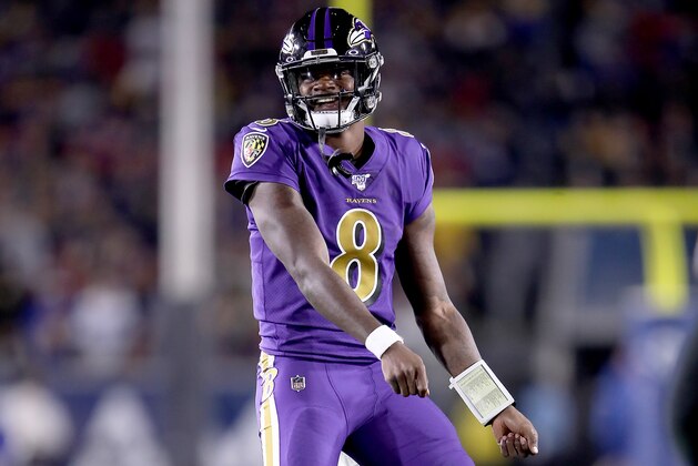 LOS ANGELES, CALIFORNIA - NOVEMBER 25:  Quarterback Lamar Jackson #8 of the Baltimore Ravens celebrates his second pass for a touchdown to wide receiver Marquise Brown #15  in the first quarter of the game against the Los Angeles Rams at Los Angeles Memorial Coliseum on November 25, 2019 in Los Angeles, California. (Photo by Sean M. Haffey/Getty Images)