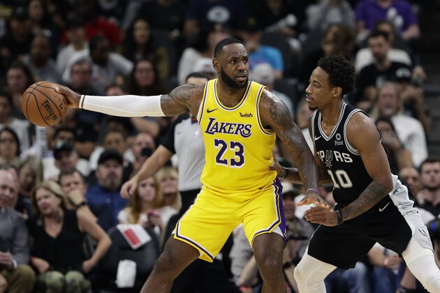 Los Angeles Lakers forward LeBron James (23) and San Antonio Spurs guard DeMar DeRozan (10) during the second half of an NBA basketball game, in San Antonio, Monday, Nov. 25, 2019. (AP Photo/Eric Gay)