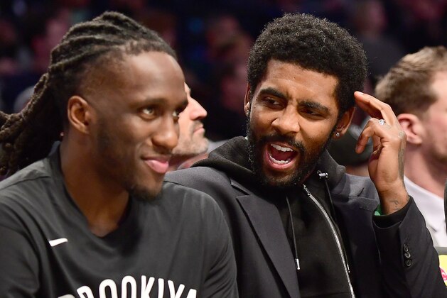 NEW YORK, NEW YORK - NOVEMBER 18: Kyrie Irving #11 of the Brooklyn Nets talks to Taurean Prince #2 on the bench during the second half against the Indiana Pacers at Barclays Center on November 18, 2019 in the Brooklyn borough of New York City. NOTE TO USER: User expressly acknowledges and agrees that, by downloading and or using this Photograph, user is consenting to the terms and conditions of the Getty Images License Agreement. (Photo by Emilee Chinn/Getty Images)